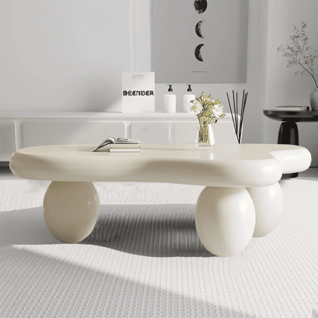 Modern white coffee table in a minimalistic room with decor items.