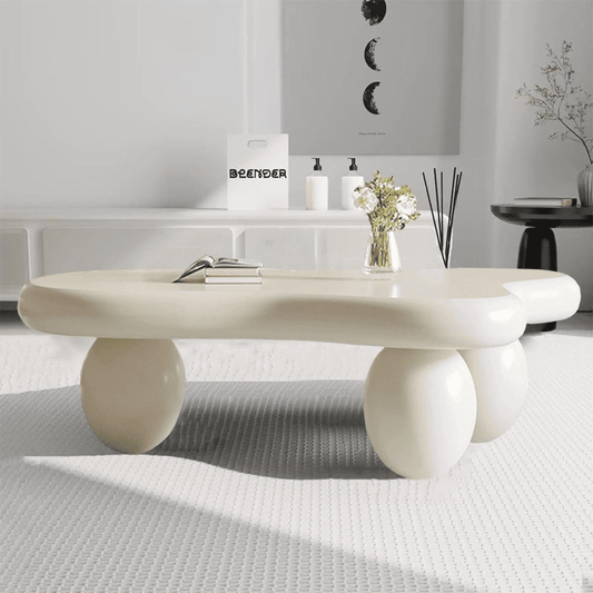 Modern white coffee table in a minimalistic room with decor items.